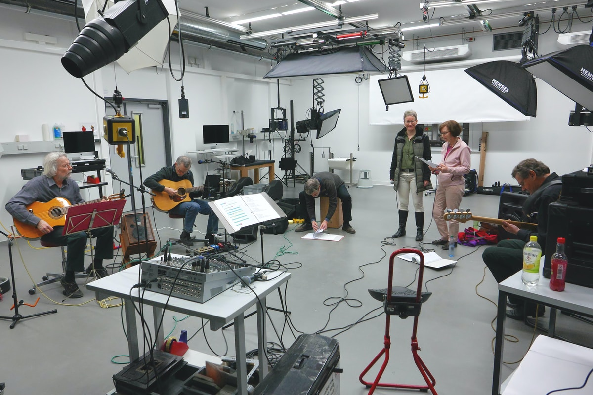 Rehearsal studio with three white guitarists